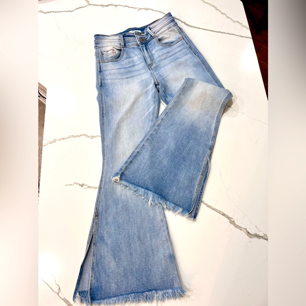 Bell bottom light blue denim jeans with a good stretch to button top